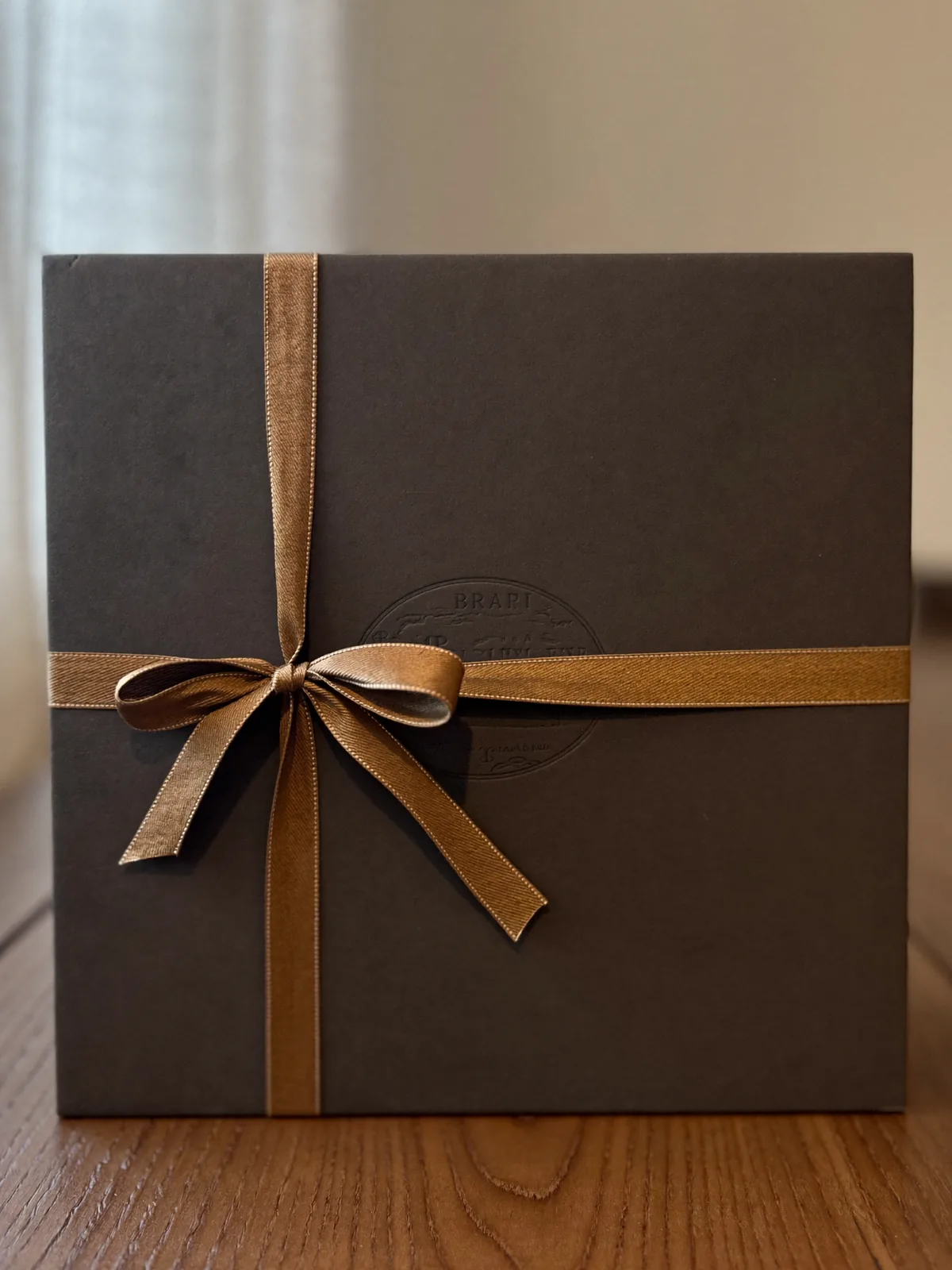 Rigid gift box with satin ribbon closure